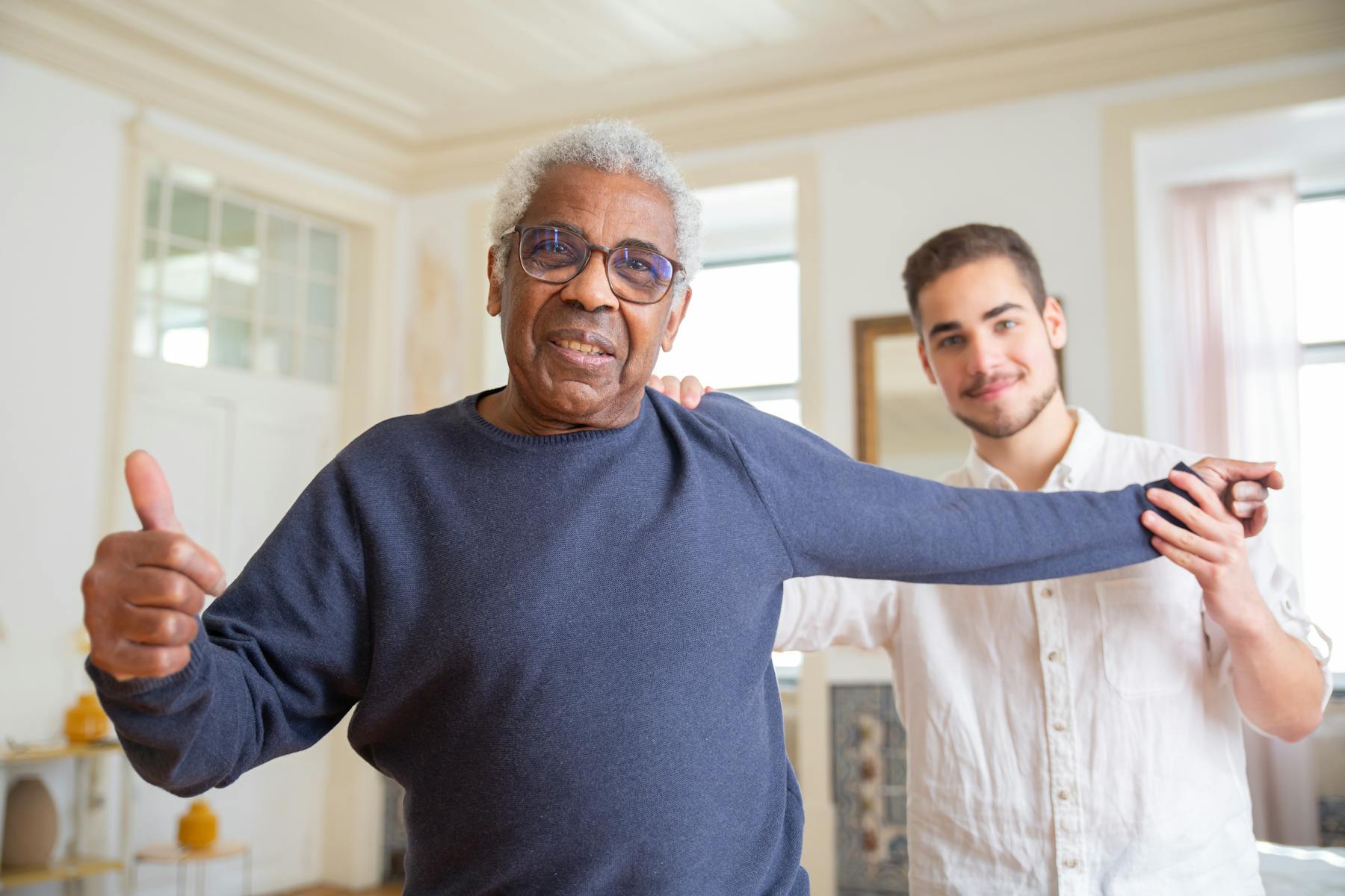 Therapist supporting an older adult during guided mobility therapy